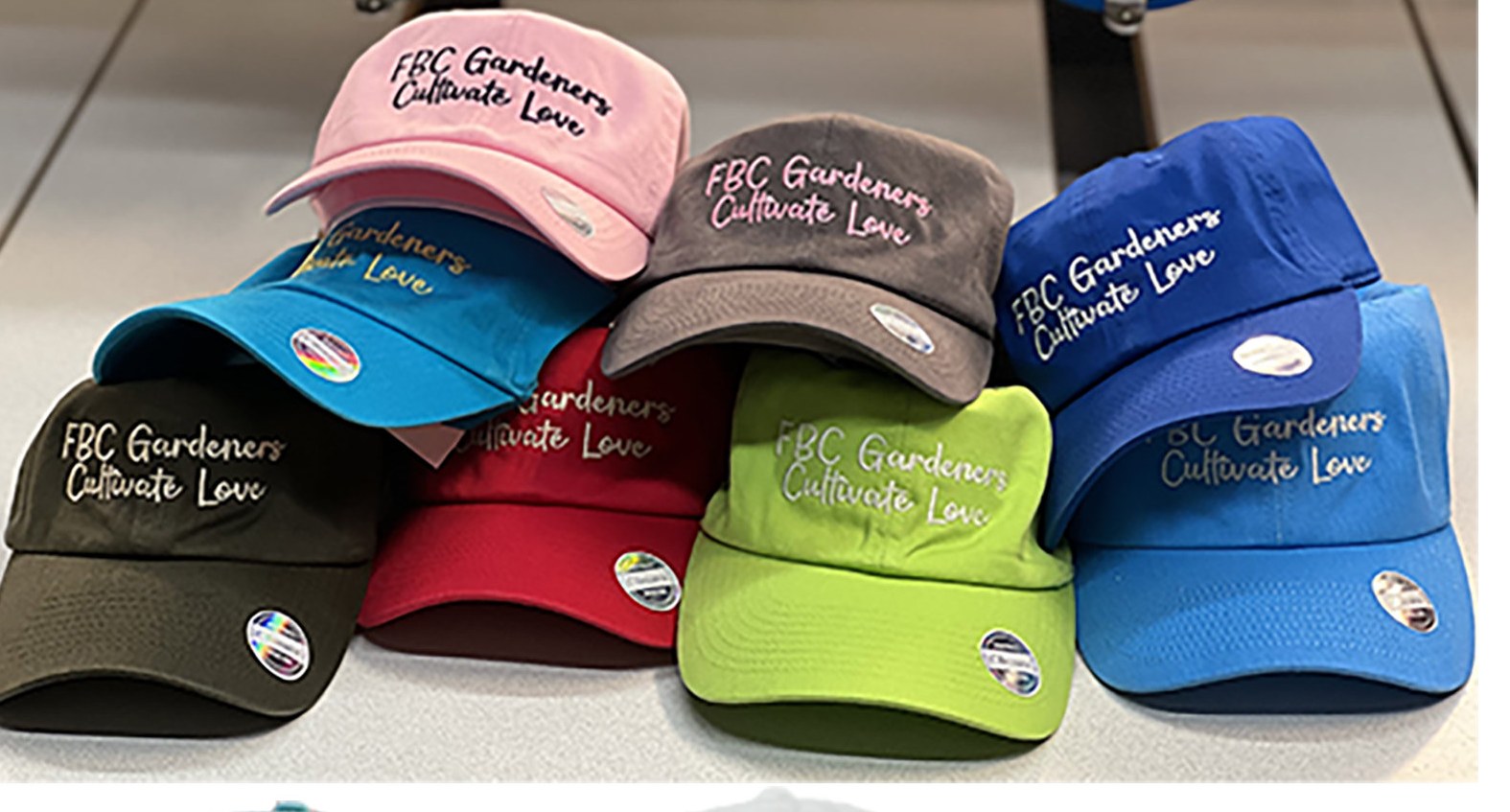 Custom team caps embroidered for FBC Gardeners in nine colours